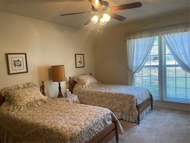 bedroom featuring ceiling fan and carpet