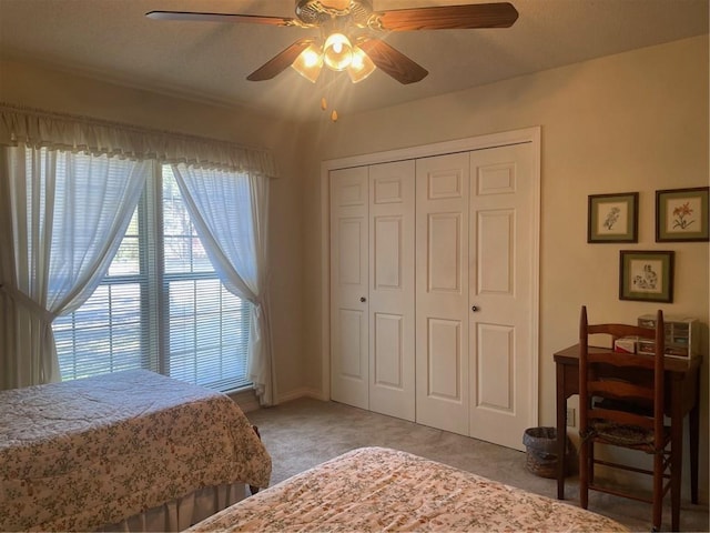 bedroom with carpet floors, a ceiling fan, and a closet