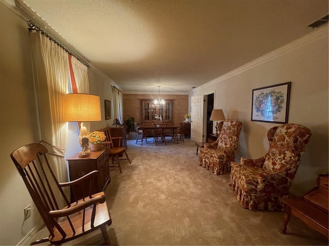 sitting room featuring a chandelier, carpet floors, visible vents, and crown molding