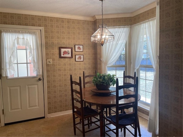 dining area featuring a wealth of natural light, baseboards, and wallpapered walls