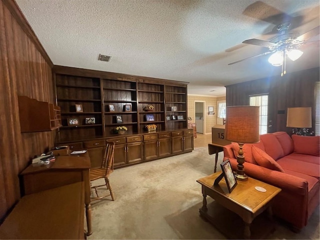 interior space featuring visible vents, light colored carpet, ceiling fan, and a textured ceiling