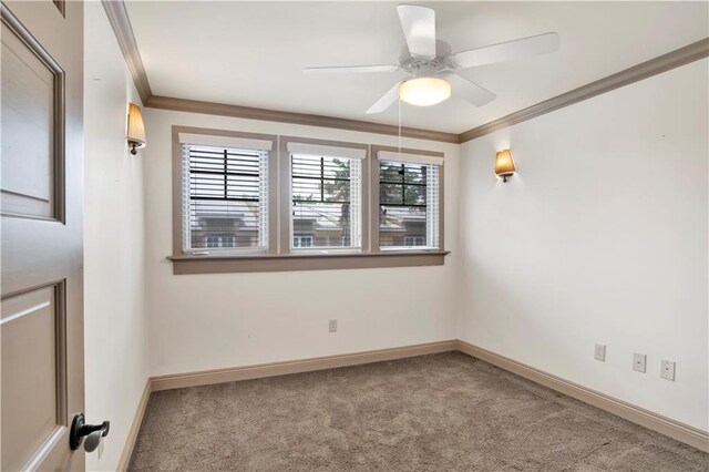 carpeted empty room with ceiling fan and ornamental molding