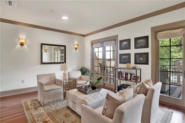 living room with french doors, crown molding, and hardwood / wood-style floors