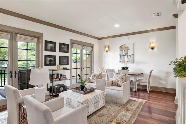 living room with wood-type flooring, ornamental molding, and french doors