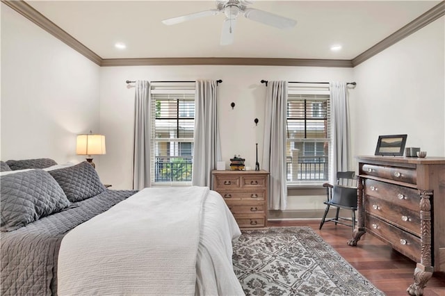 bedroom with dark hardwood / wood-style floors, ceiling fan, and ornamental molding