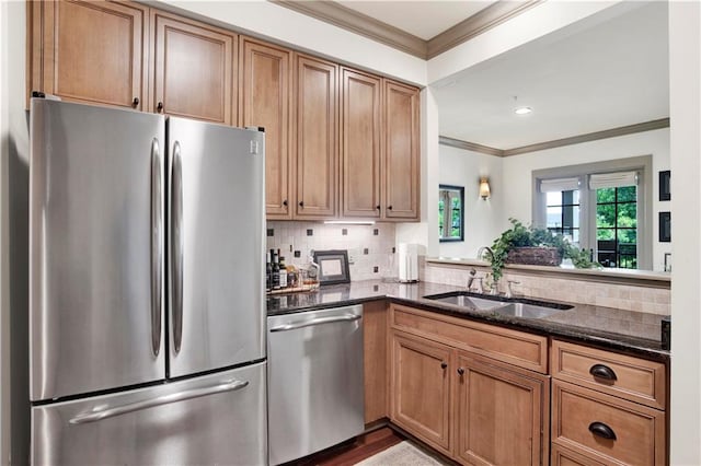 kitchen featuring dark stone countertops, tasteful backsplash, stainless steel appliances, hardwood / wood-style flooring, and sink