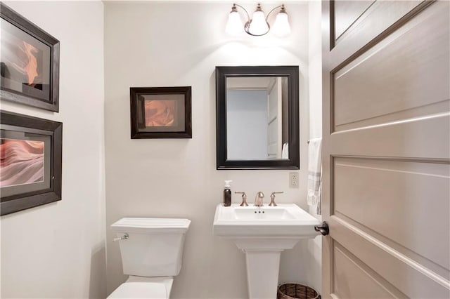 bathroom featuring toilet and sink