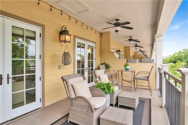 balcony with ceiling fan and french doors