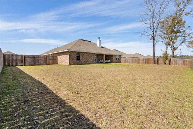 view of yard with a fenced backyard