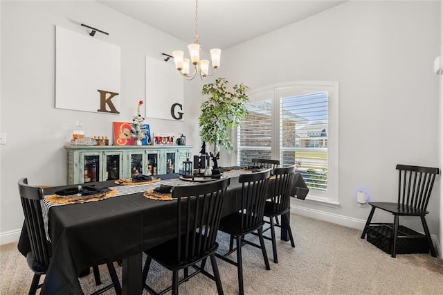 dining space featuring baseboards, light carpet, and an inviting chandelier