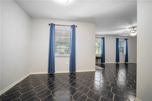 7072 Forest Glenn Ct, Irvington, AL 36544 - empty room featuring a textured ceiling and a ceiling fan
