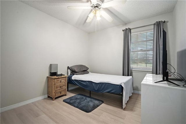 7072 Forest Glenn Ct, Irvington, AL 36544 - bedroom featuring light wood-style flooring, a textured ceiling, and a ceiling fan