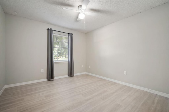 7072 Forest Glenn Ct, Irvington, AL 36544 - empty room with a textured ceiling, light wood-type flooring, and a ceiling fan