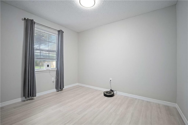 7072 Forest Glenn Ct, Irvington, AL 36544 - spare room with light wood-style floors and a textured ceiling