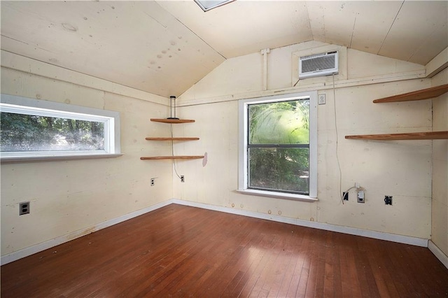 7072 Forest Glenn Ct, Irvington, AL 36544 - unfurnished room featuring vaulted ceiling, wood-type flooring, plenty of natural light, and an AC wall unit
