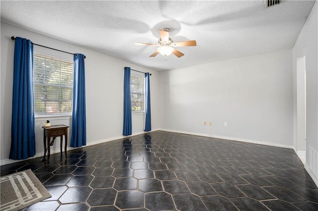 7072 Forest Glenn Ct, Irvington, AL 36544 - unfurnished room featuring healthy amount of natural light, a ceiling fan, and a textured ceiling