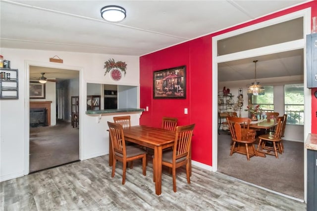 dining room featuring lofted ceiling, hardwood / wood-style floors, and ceiling fan