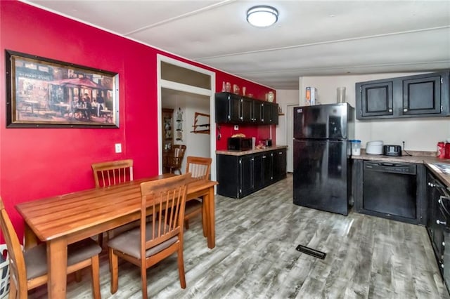 kitchen featuring light hardwood / wood-style flooring and black appliances