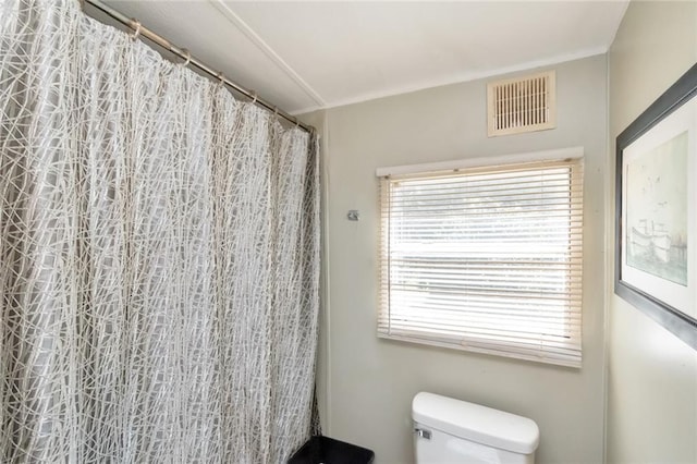 bathroom with toilet and walk in shower