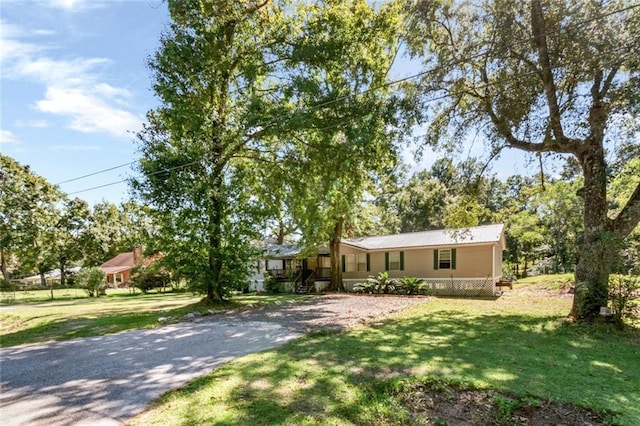 ranch-style home with a porch and a front yard