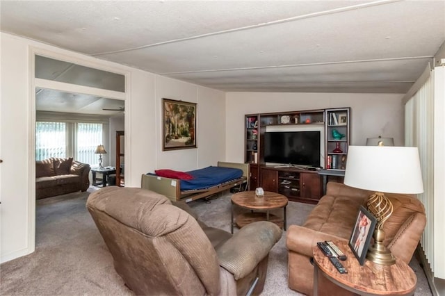 living room featuring carpet and vaulted ceiling