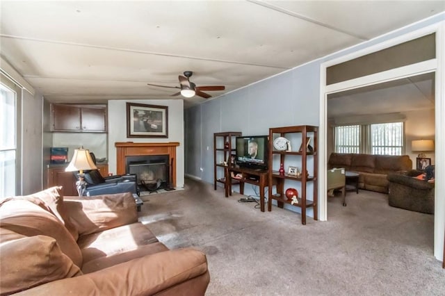 carpeted living room featuring ceiling fan and plenty of natural light