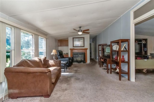 carpeted living room featuring ceiling fan and lofted ceiling