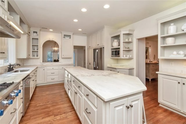 kitchen featuring a center island, stainless steel appliances, and white cabinets