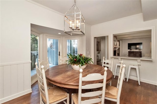 dining area with crown molding, a healthy amount of sunlight, a notable chandelier, and dark hardwood / wood-style flooring