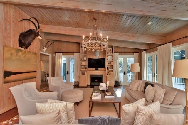 living room featuring wooden walls, vaulted ceiling with beams, and french doors