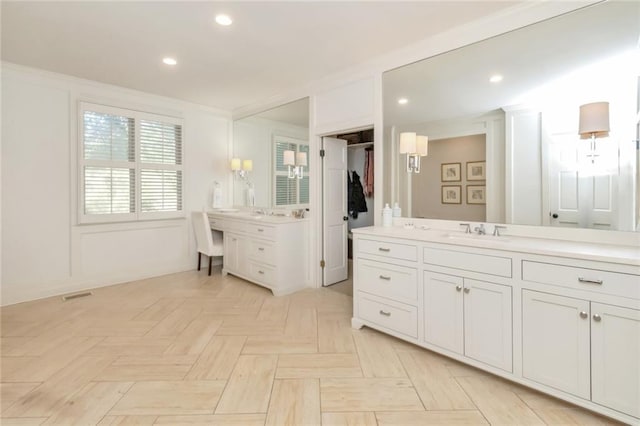 bathroom with vanity, ornamental molding, and parquet flooring