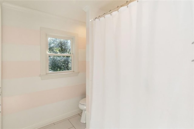 bathroom with tile patterned flooring, a shower with shower curtain, and toilet