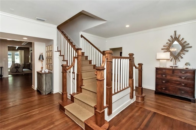 stairs with crown molding and wood-type flooring