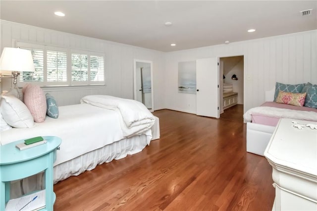 bedroom featuring dark wood-type flooring and ensuite bath