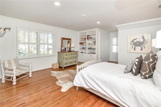 bedroom featuring ornamental molding and hardwood / wood-style flooring