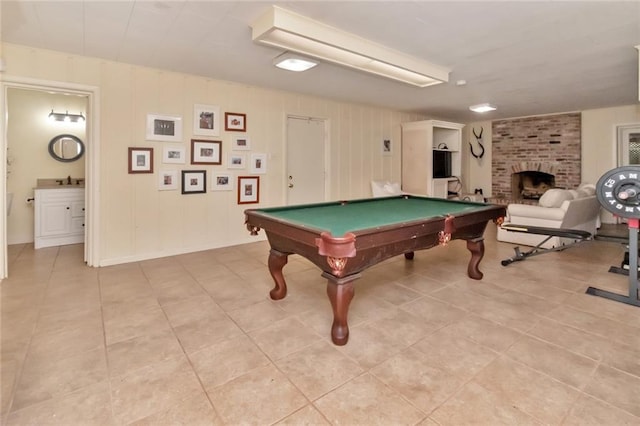 rec room with a fireplace, light tile patterned floors, and pool table