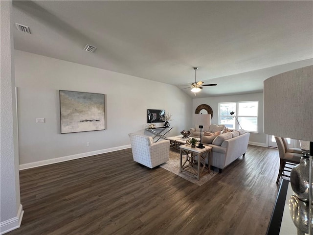 living room with ceiling fan, dark wood-type flooring, and lofted ceiling