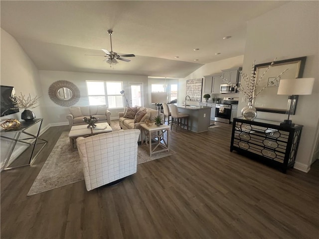 living room featuring sink, vaulted ceiling, ceiling fan, and dark hardwood / wood-style floors