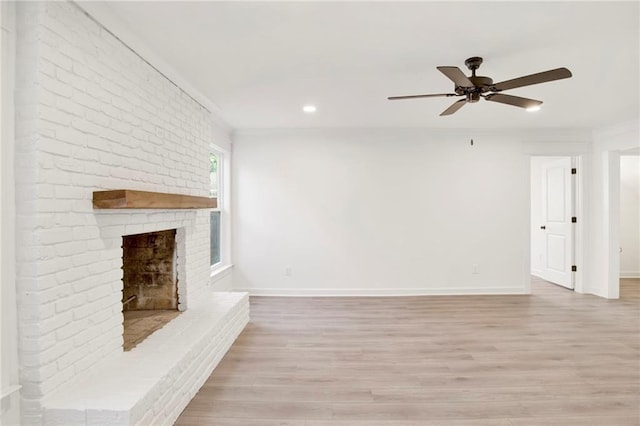 unfurnished living room with a fireplace, ceiling fan, and light wood-type flooring