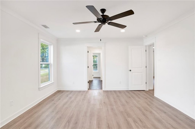 spare room with light wood-type flooring, ceiling fan, and crown molding