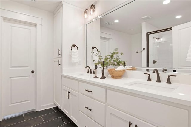 bathroom with vanity, tile patterned floors, and a shower with door