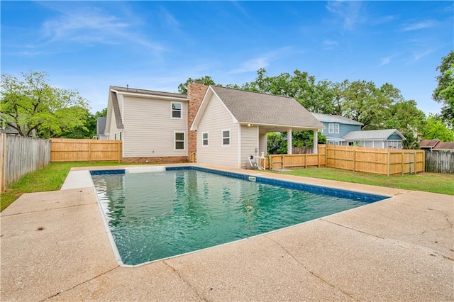 view of pool with a patio area and a yard