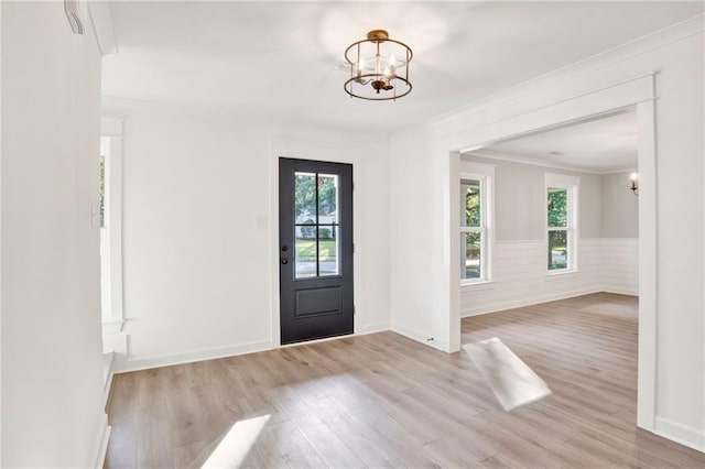 foyer featuring light hardwood / wood-style floors, plenty of natural light, and a notable chandelier