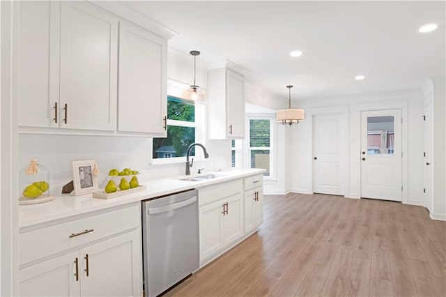 kitchen featuring light hardwood / wood-style floors, dishwasher, white cabinets, sink, and pendant lighting