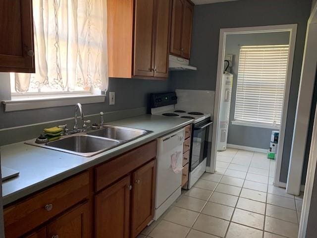 kitchen with light tile patterned flooring, white appliances, and sink