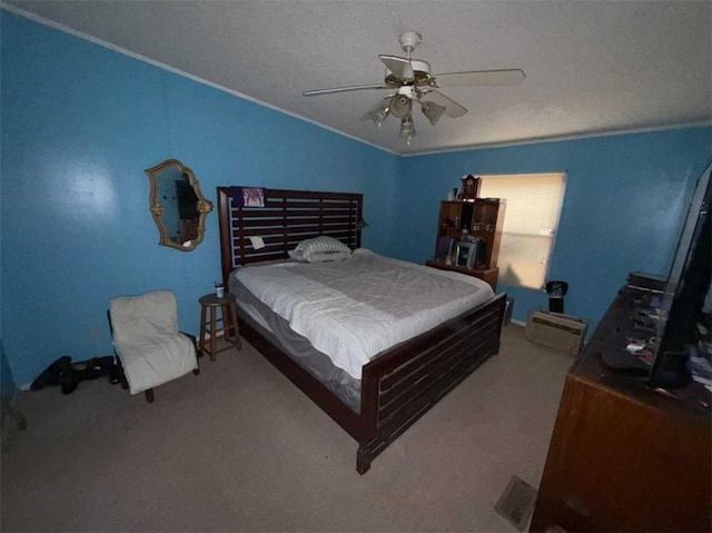 bedroom with ceiling fan, ornamental molding, carpet floors, and a textured ceiling