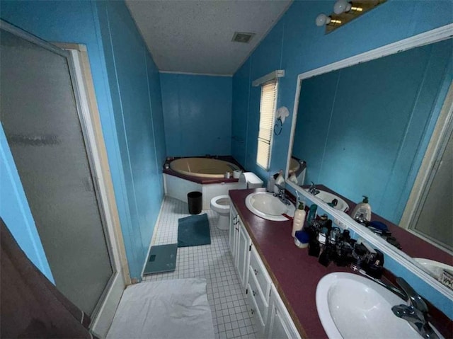 bathroom with vanity, separate shower and tub, tile patterned floors, and a textured ceiling