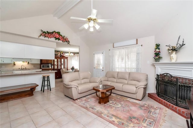 living room featuring light tile patterned floors, beam ceiling, high vaulted ceiling, ceiling fan with notable chandelier, and sink