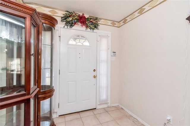 foyer entrance with light tile patterned floors