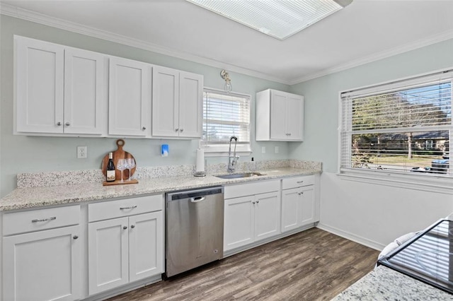 kitchen featuring dishwasher, a healthy amount of sunlight, white cabinetry, and ornamental molding